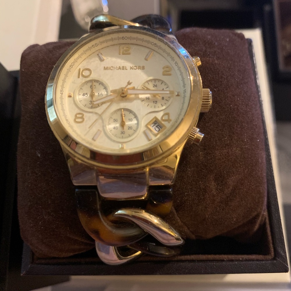 Used Michael Kors watch. Gold with bracelet band.
